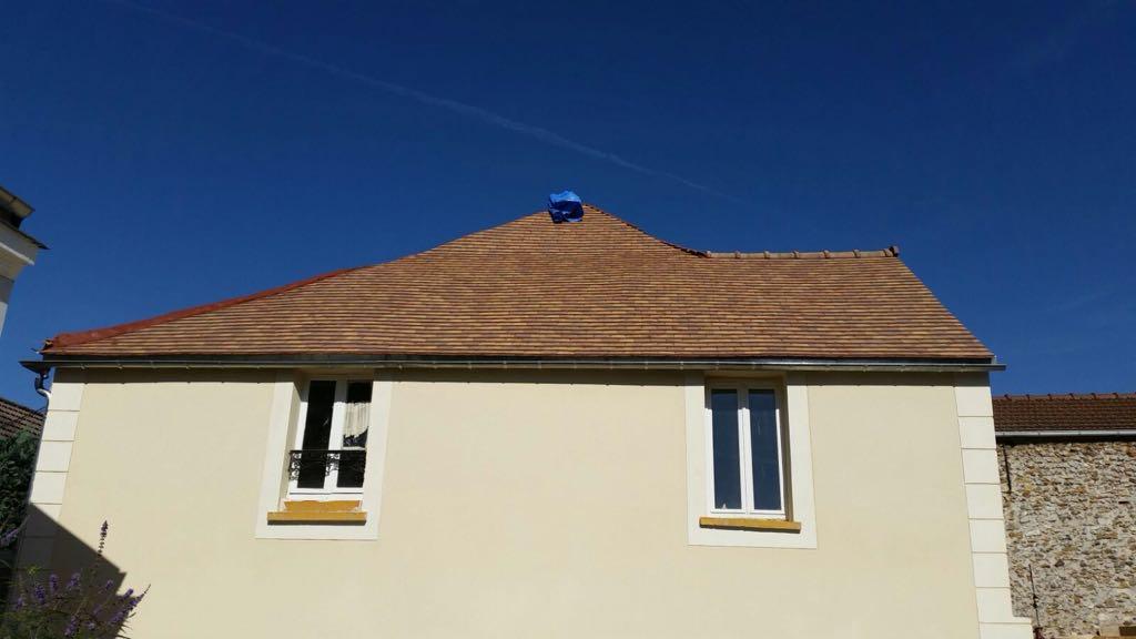 Maison rénovée : toiture en tuiles refaite et façade enduite ton crème, fenêtres neuves
